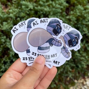 A sticker of a robot holding a bag over his shoulder.