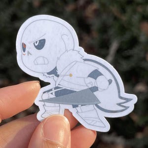 A skeleton character holding a giant knife blade and preparing for battle.