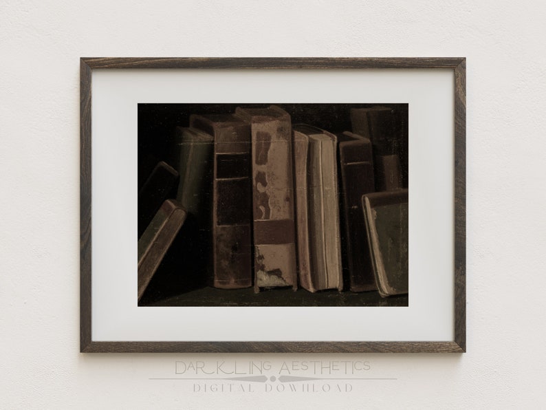 May include: A framed print of a still life featuring a stack of old, worn books with brown leather covers. The books are arranged in a row, with the spines facing the viewer. The image has a dark, moody aesthetic.