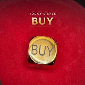 K&ouml;nnte beinhalten: Ein goldfarbener W&uuml;rfel mit dem Wort BUY in schwarzer Schrift auf der Oberseite. &Uuml;ber dem W&uuml;rfel ist der Text TODAY'S CALL BUY in Wei&szlig; und Gold vor einem leuchtend roten Hintergrund zu sehen, was eine markante Komposition ergibt.