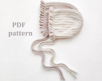 May include: Two knitted baby bonnets with ties, one in a light beige color and the other in a light brown color. The bonnets are laid out on a white surface. The text "PDF pattern" is written in the image.