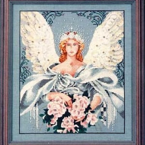 May include: Framed cross-stitch artwork depicting an angel with large, detailed white wings. The angel has red hair, a crown, and holds a bouquet of pink flowers. The artwork is framed in a brown wooden frame with a blue mat.