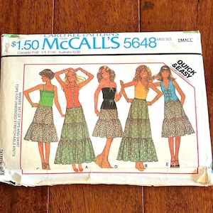 May include: Vintage McCall's sewing pattern number 5648 for a misses' set of tops and skirt. The pattern is for unbonded stretchable knits and is quick and easy to sew. The pattern envelope shows four different styles of tops and skirts, all with a floral print.