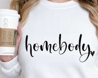 May include: White sweatshirt with the text "homebody" in black cursive lettering with a small heart symbol.