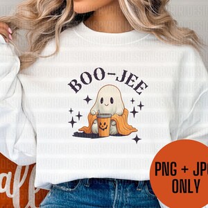 May include: White sweatshirt with a ghost holding a pumpkin spice latte and the text "BOO-JEE" in black.
