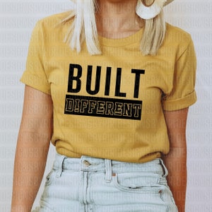 May include: A yellow t-shirt with the text "BUILT DIFFERENT" in black letters.