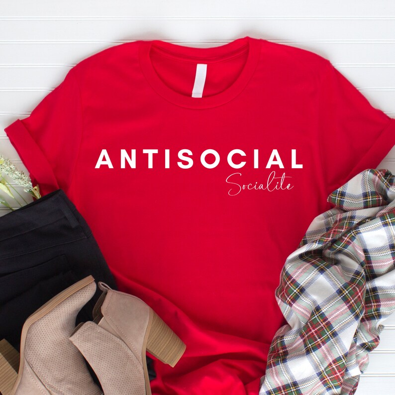 May include: Red t-shirt with white text that reads "ANTISOCIAL Socialite".