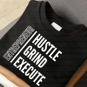 May include: Black sweatshirt with white text that reads "Entrepreneur Hustle Grind Execute".