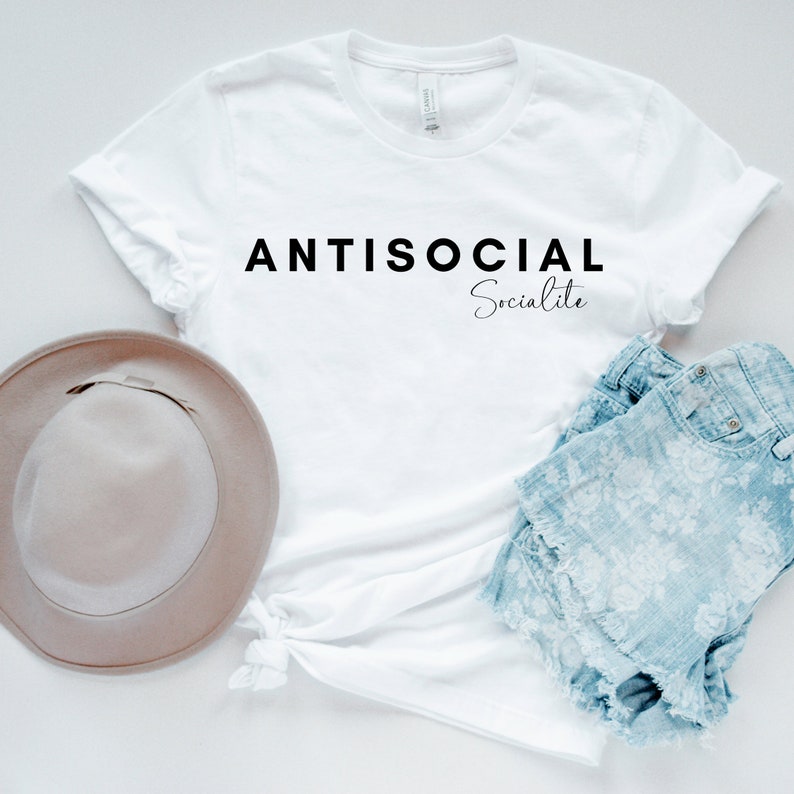 May include: White t-shirt with the text "ANTISOCIAL Socialite" printed in black.