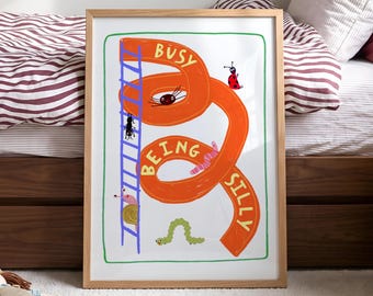 May include: A framed rectangular wall art print featuring a large orange winding shape with the text BUSY BEING SILLY written in yellow. The illustration includes a blue ladder, a ladybug, a spider, a snail, and a green caterpillar.