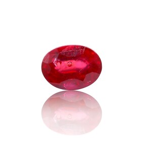 May include: A deep red oval-shaped gemstone with a smooth, polished surface.