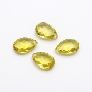 Może przedstawiać: Cztery fasetowane, żółte koraliki w kształcie łzy.