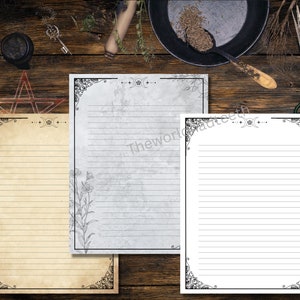 May include: Three printable stationery sheets with a decorative border and a moon and crescent moon design. The sheets are in different colors: beige, gray, and white.