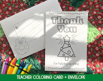 May include: A white coloring card and envelope set with a Christmas tree design and the words "Thank You". The card includes the text "For helping me shine!" and a space to write "To:". Crayons are visible.