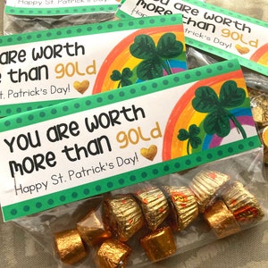 May include: A clear plastic bag filled with small gold-wrapped candies. The bag has a green and rainbow patterned tag attached to it that reads "You are worth more than gold! Happy St. Patrick's Day!"