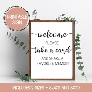Może przedstawiać: Drukowana tabliczka z brązową ramą i białym tłem. Tabliczka zawiera napis "welcome please take a card and share a favorite memory". Dostępna w dw&oacute;ch rozmiarach: 8,5x11 i 8x10 cali.