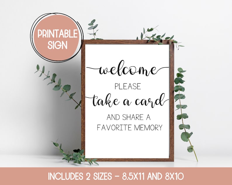 Może przedstawiać: Drukowana tabliczka z brązową ramą i białym tłem. Tabliczka zawiera napis "welcome please take a card and share a favorite memory". Dostępna w dw&oacute;ch rozmiarach: 8,5x11 i 8x10 cali.