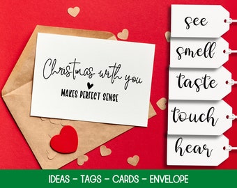 May include: A brown envelope with a white card inside that says "Christmas with you makes perfect sense". There are five white tags with the words "see", "smell", "taste", "touch", and "hear" written on them.
