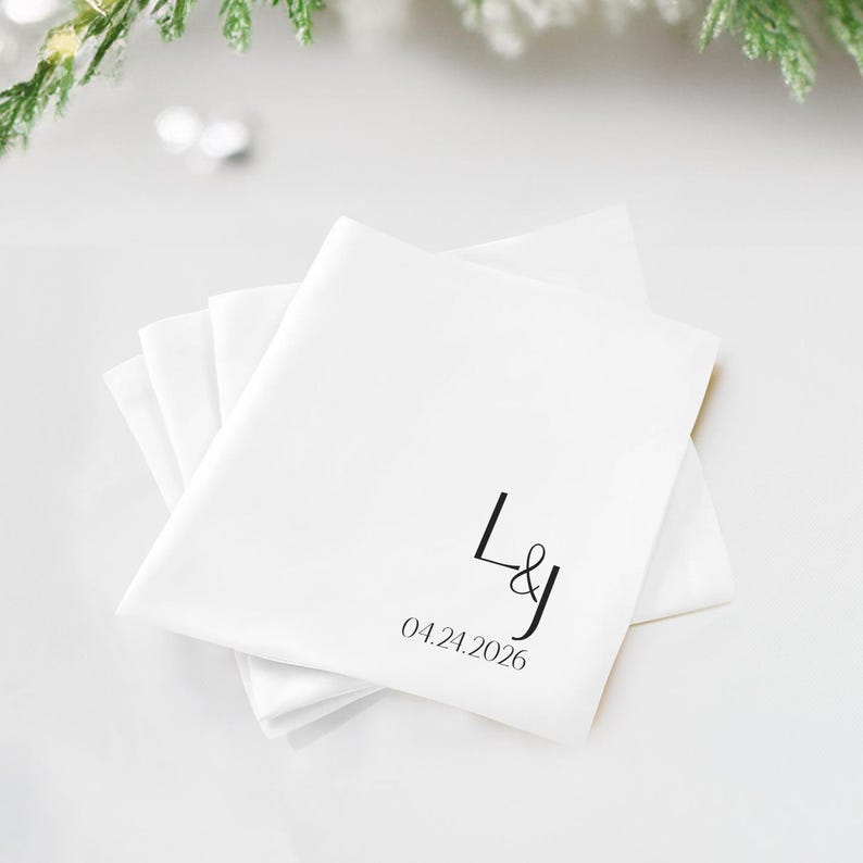 White napkins with black initials "L&J" and date "04.24.2026".