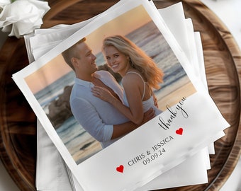 May include: White wedding thank you card with a photo of a couple on a beach at sunset. The card has red hearts and the text "Thank you" and "Chris & Jessica 09.09.24".