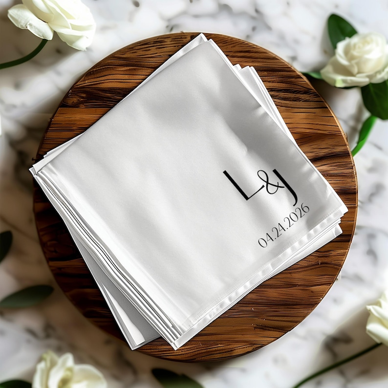 White linen napkin with "L&J" monogram and "04.24.2026" date.