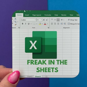 May include: A square coaster featuring a printed Microsoft Excel interface graphic with the green X logo and the text FREAK IN THE SHEETS in bold green letters. The design includes a spreadsheet grid, a ribbon menu, and sheet tabs.