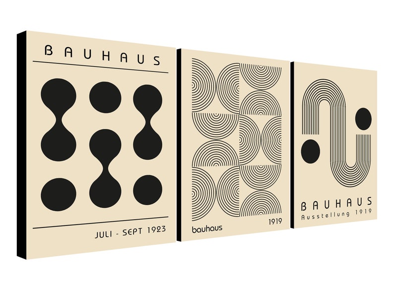 May include: Three beige canvas prints with black geometric designs. The first print features a pattern of black circles and ovals. The second print features a pattern of black semi-circles. The third print features a black curved line with a circle at the end. The text "BAUHAUS" is on the first and third prints. The text "Juli - Sept 1923" is on the first print. The text "bauhaus" is on the second print. The text "1919" is on the second and third prints. The text "Ausstellung 1919" is on the third print.