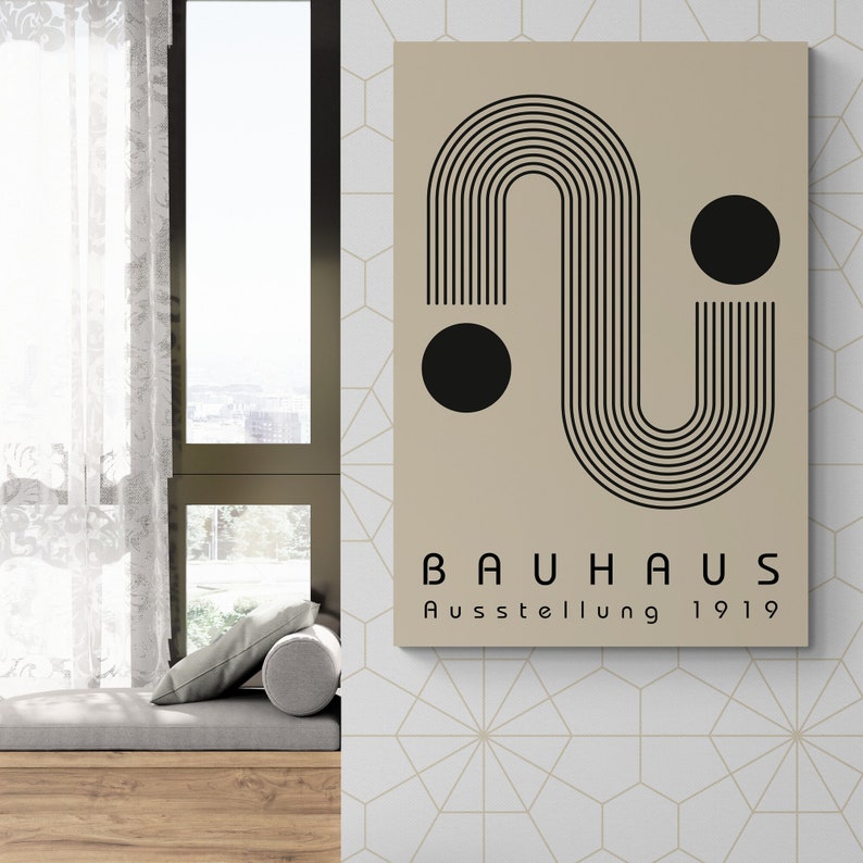 May include: A beige poster with a black geometric design featuring a curved line and two circles. The text "BAUHAUS Ausstellung 1919" is printed at the bottom of the poster.