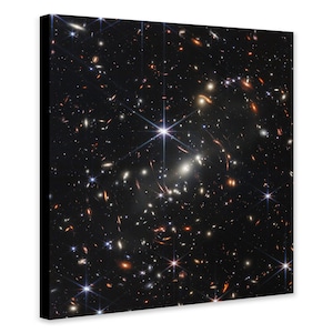 May include: A black and white photograph of a star cluster with many stars and galaxies visible. The stars are bright and white, and the galaxies are faint and fuzzy.