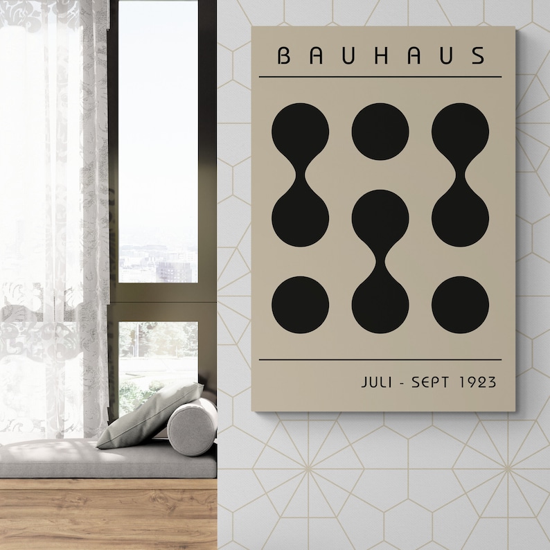 May include: A beige poster with black text that reads "BAUHHAUS" and "JULI - SEPT 1923". The poster features a geometric design of nine black circles and ovals.
