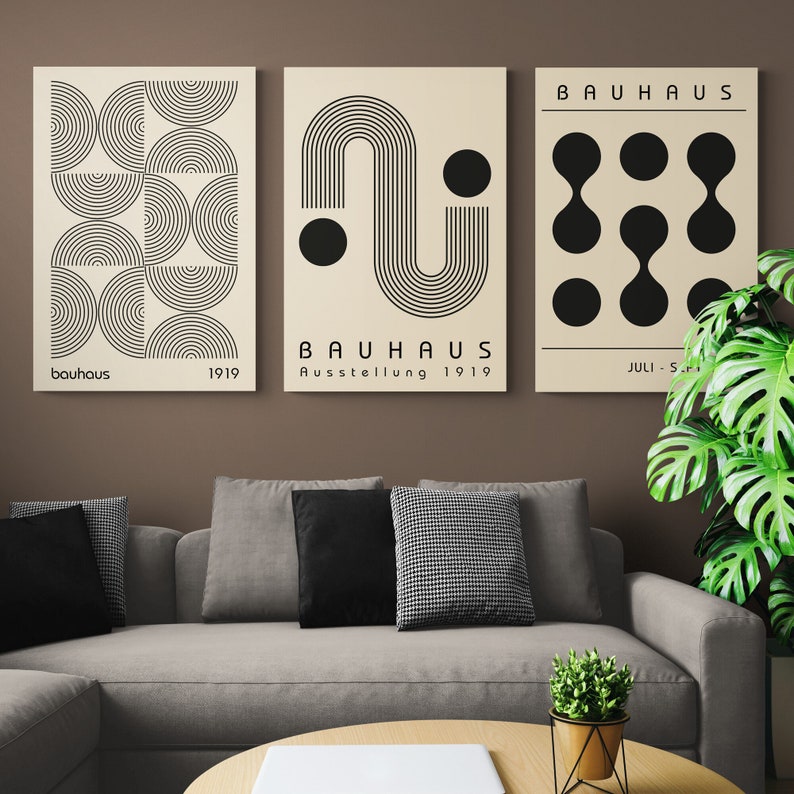 May include: Three minimalist art prints with black and white geometric designs. The prints feature the text "Bauhaus" and "Ausstellung 1919".