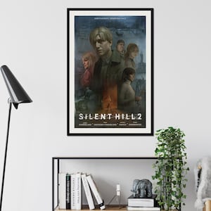 May include: A black and white poster with the title "Silent Hill 2" in a white font. The poster features a group of characters from the video game, including a man with a red shirt and a woman with a blue shirt. The poster is framed in a black frame.