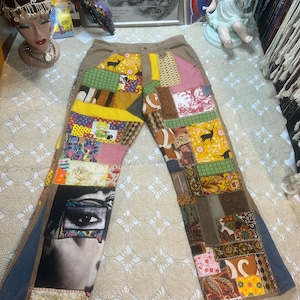 May include: Patchwork jeans with a variety of fabric patterns and colors. The jeans feature a collage of different fabrics, including floral, geometric, and portrait prints. The jeans have a brown waistband and denim accents.
