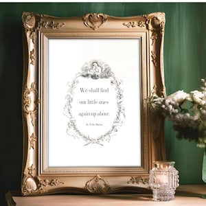 May include: A framed print featuring a black and white illustration of a wreath of flowers and leaves. The quote "We shall find our little ones again up above. St. Zita Maria" is printed within the wreath.