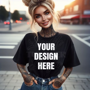 May include: A woman wearing a black t-shirt with the text "YOUR DESIGN HERE" printed on it. She is standing in a city street with her hands in her pockets.