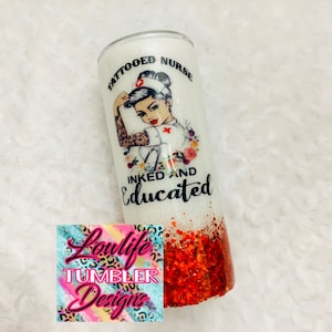 May include: White tumbler with red glitter at the bottom. The tumbler features a graphic of a tattooed nurse with the text "Tattooed Nurse Inked and Educated".
