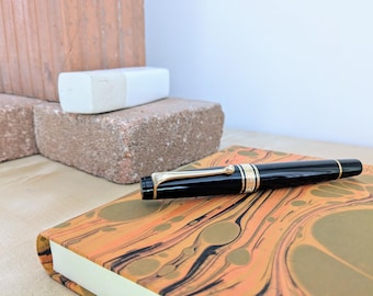 Aurora Optima 997N, Fountain pen in precious black resin and 14k gold nib.