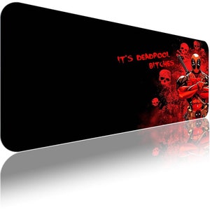 May include: Black rectangular mouse mat with a red and black graphic of Deadpool. The design includes the text "IT'S DEADPOOL BITCHES" in red, and several red skulls.