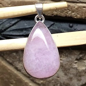 Peut inclure: Un pendentif en forme de larme avec une pierre pr&eacute;cieuse rose clair sertie dans de l'argent sterling.