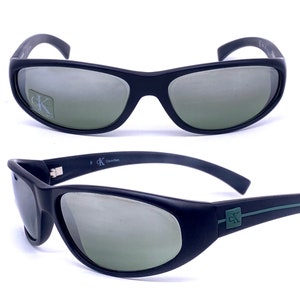 Calvin Klein 3019 matt black sporty wrap sunglasses w grey slightly mirrored lenses, NOS 90s Italy