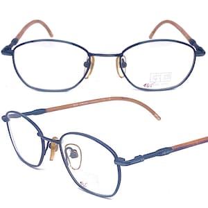 May include: Black metal spectacles with brown temples. The glasses have a rectangular shape and are designed with a double bridge. The text "GS 301 16.5cm 1100" is printed on the right temple.