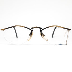 YABI-spirit minimal matt gold metallic eyeglasses frames in rimless design with pointing browline, 1980s NOS Germany.