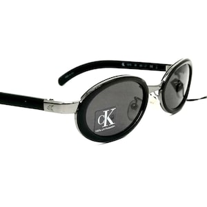 Occhiali da sole ovali neri minimalisti Calvin Klein 1015 made in Italy NOS anni &#39;90
