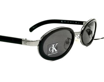 Occhiali da sole ovali neri minimalisti Calvin Klein 1015 made in Italy NOS anni &#39;90