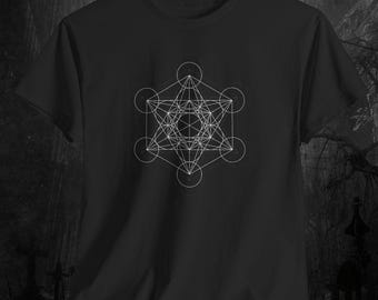 May include: Black t-shirt with a white geometric design. The design is a complex pattern of interconnected circles, lines, and shapes, creating a symmetrical and intricate visual. The shirt is made of a soft material.