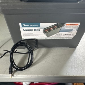 May include: A gray plastic ammo box with a black power cord and a black plug. The box has a label that says "Ammo Box" and "Bunker Hill Security". The label also lists the uses for the box, including ammunition, fishing gear, electronics, and camera equipment.