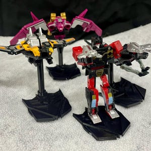 Masterpiece Transformers Cassettes stands