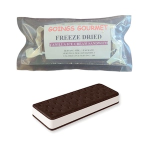 May include: An image of a freeze-dried vanilla ice cream sandwich. The sandwich has a rectangular shape with a white ice cream center and two dark brown cookie wafers. The packaging reads "GOINGS GOURMET FREEZE DRIED VANILLA ICE CREAM SANDWICH."