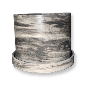 May include: A grey and white planter with a wood grain pattern. The planter has a matching saucer.