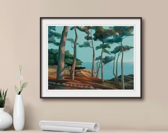 May include: A framed landscape painting depicting a coastal scene with tall pine trees, rocky terrain, and a calm blue sea under a clear sky. The artwork features warm brown and orange earth tones contrasted with deep green foliage and light blue water.